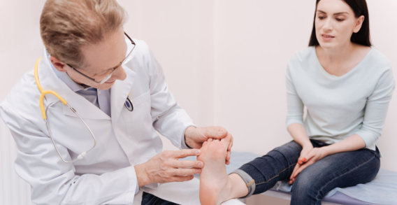 doctor checking the patients foot
